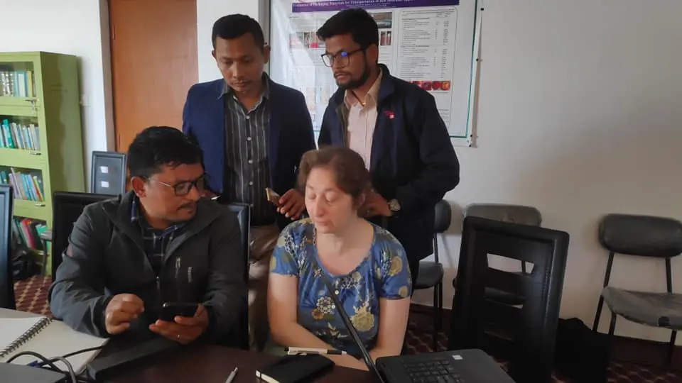 Researchers reviewing project data together during an indoor collaboration meeting